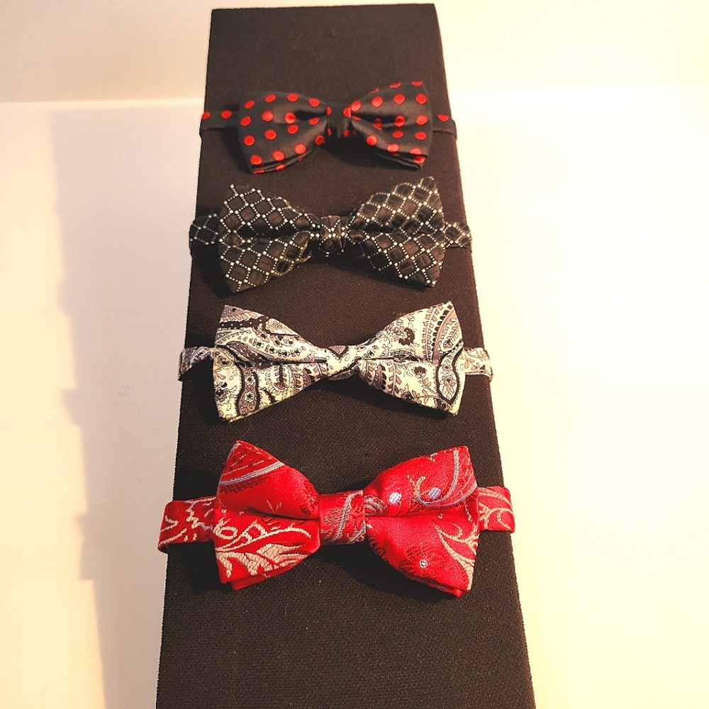 4 pre-tied bow ties, in reds, black, gray,and white assorted prints